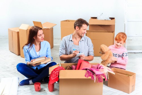 Moving team handling boxes and furniture during a Friernbarnet relocation