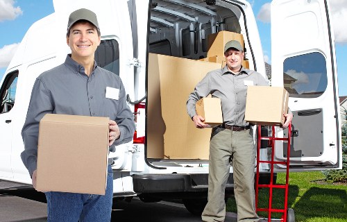 Careful loading of a piano into a removal vehicle for local delivery